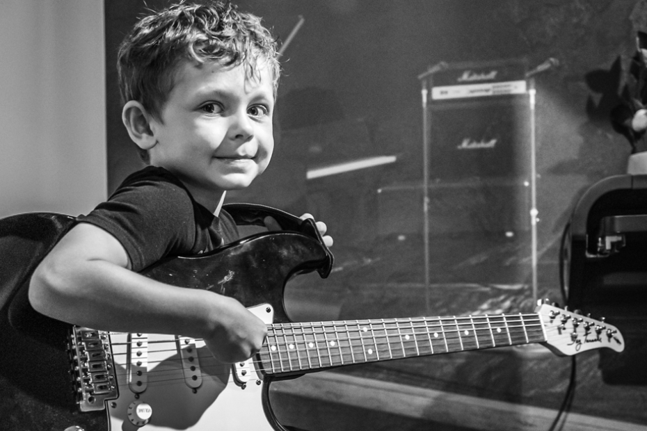 Kid playing guitar.